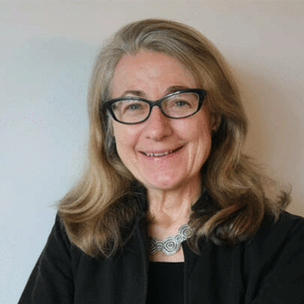 Photo of Julia Adeney Thomas, a white woman wearing glasses with shoulder length wavy hair and a dark suit jacket and top.