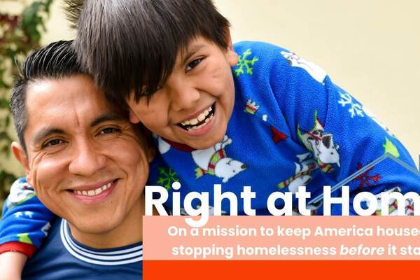 Smiling man in blue shirt embraces joyful child in blue polar bear top from behind, both laughing. Text on graphic says "Right at Home: On a mission to keep America housed by stopping homelessness before it starts."